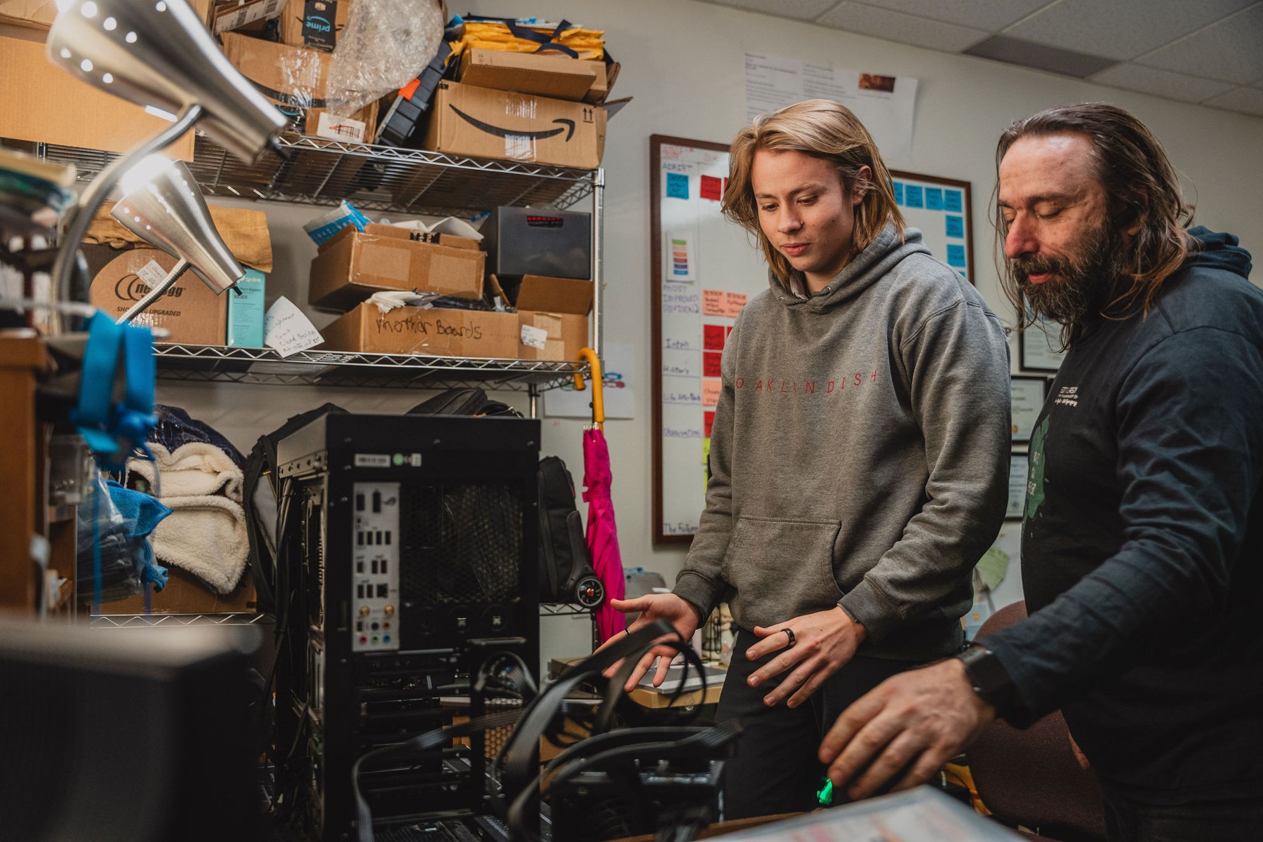 A student and mentor examining computer hardware