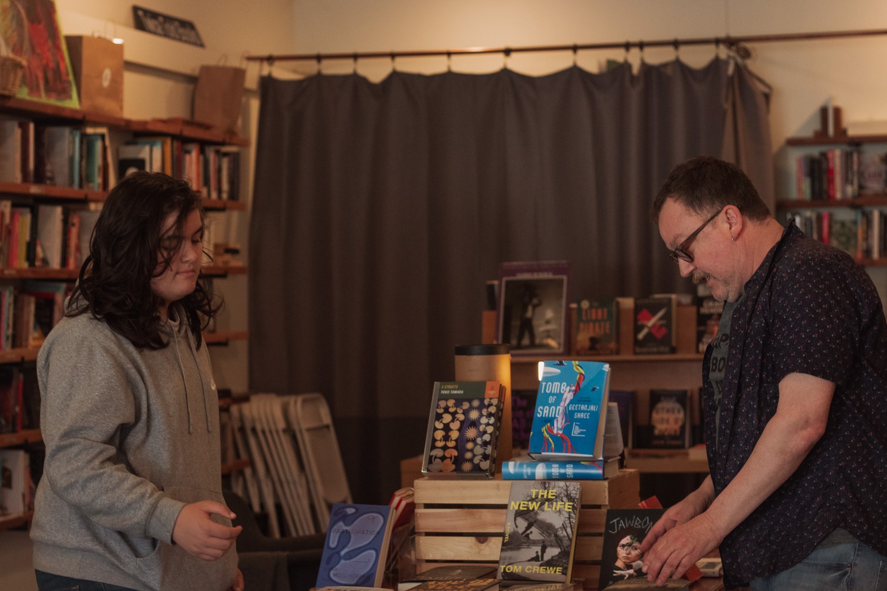 A student and mentor exploring products at a local business